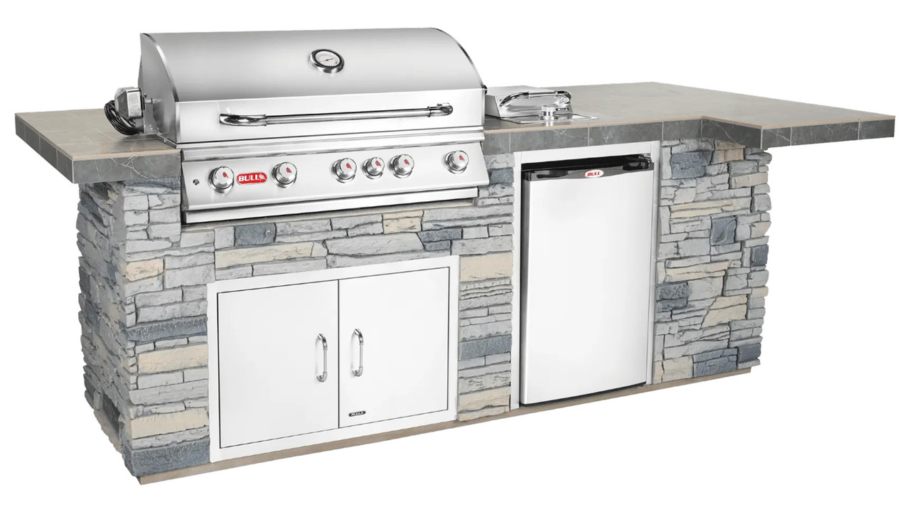 Bull stainless steel grill and side burner built into an outdoor kitchen counter — Austin TX