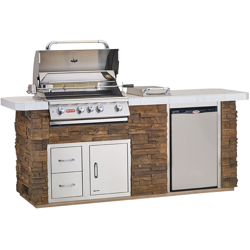 Bull stainless steel built-in grill set into a stone outdoor kitchen counter — Austin TX
